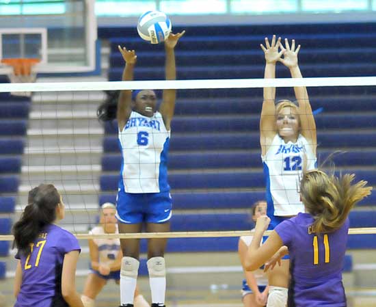 Brianna White and McKenzie Rice go up for a block at the net during Tuesday's season-opener for the Bryant Lady Hornets volleyball team. (Photo by Kevin Nagle)