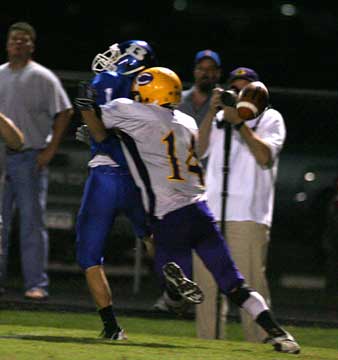 Sawyer Nichols absorbs a hit on a pass attempt against Little Rock Catholic last season. (Photo by Rick Nation)