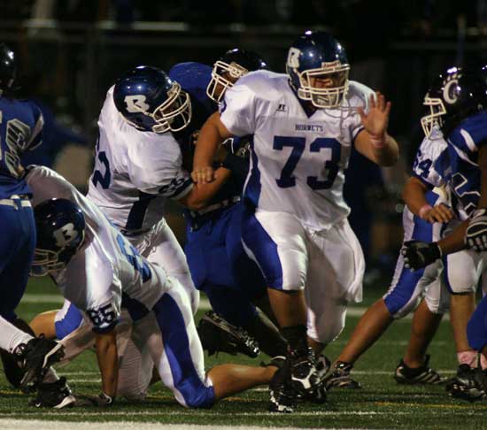 Cody Elmore (85), Landon Pickett (62) and Justin Rauch (73) clear some space against Conway in 2009. (Photo by Rick Nation)