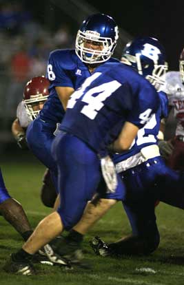 Quarterback Blake Davidson (8) fakes a handoff to fullback Dylan Pritchett (44). (Photo by Rick Nation)