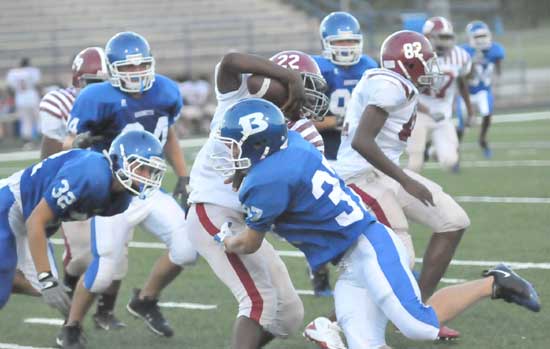 Bryant's Hunter Berry (37) and Parker Dunn (32) converge on a Pine Bluff running back during Monday's junior varsity game. (Photo by Kevin Nagle)