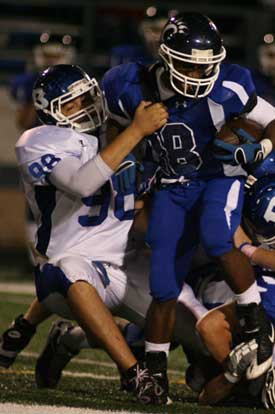 Josh Hampton makes a tackle against Conway. (Photo by Rick Nation)