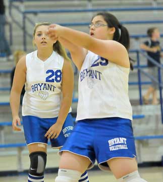 Makayla Nguyen (29) returns a serve in front of teammate Charli Sahr (28) during Monday's match against Conway. (Photo by Kevin Nagle) 