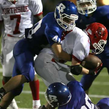 Dylan Blasi (40) rides down Northside quarterback Tanner Knight. (Photo by Rick Nation)