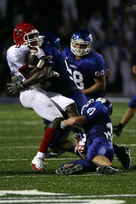 Holden Chavis (30) and a teammate team up on Northside receiver Shaquille Jones. (Photo by Rick Nation)