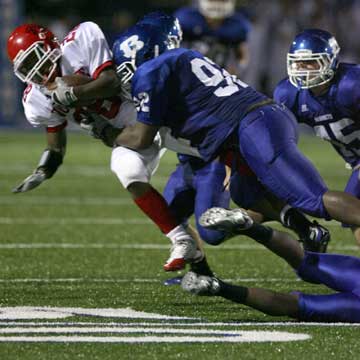 Bryant's James Kidd (92) knocks down Northside running back Devonte Carter as help arrives in the form of linebacker Collin Chapdelaine (45). (Photo by Rick Nation)