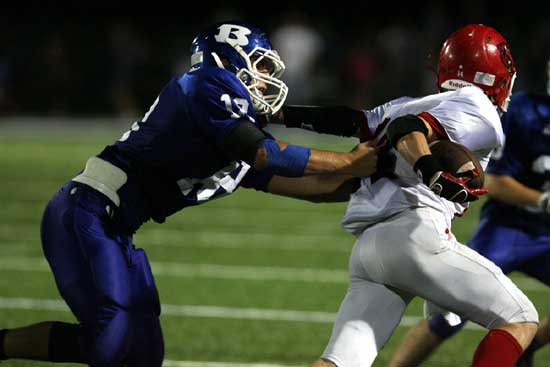 Bryant's Hunter Mayall, left, tracks down Northside quarterback Tanner Knight. (Photo by Rick Nation)
