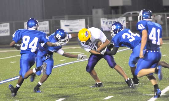 Bryant defenders Marquis Hood (84), Walter Dunn (34), Cameron Price (41) close in to help tackle a Catholic receiver. (Photo by Kevin Nagle)