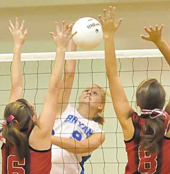 Maggie Hart (9) tries to sneak a hit between Russellville defenders. (photo by Kevin Nagle)