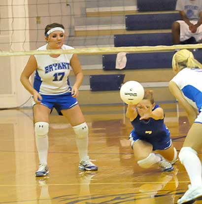Lauren Reed dives to dig up a serve in front of teammate Sydney Manley. (Photo by Kevin Nagle)
