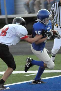 Bryant White's Drew Tipton crosses the goal line ahead of a Russellville defender. (Photo by Kevin Nagle)