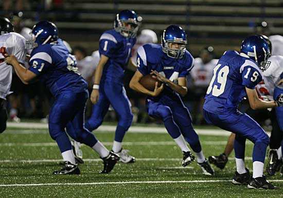 Aaron Leonard cuts upfield off blocks by Kurt Calley (61) and Jacob Thomas (19) after taking a handoff from quarterback Dakota Besancon. (Photo by Rick Nation)