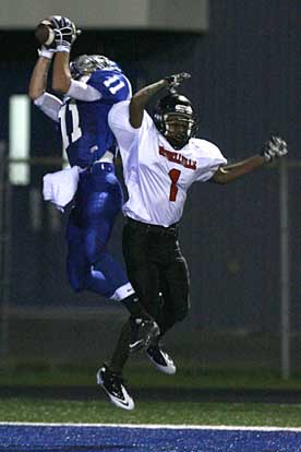 Austin Miller (11) reaches up and grabs a touchdown pass over Russellville's Steven Banyard. (Photo by Rick Nation)