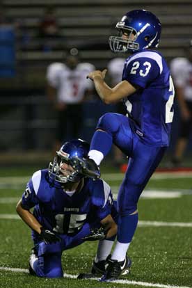 Davis Nossaman kicks an extra points out of the hold of Jacob Irby. (Photo by Rick Nation)