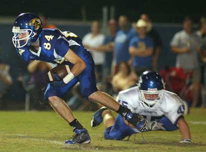 Bryant's Collin Chapdelaine (45) tries to trip up a Sheridan ball carrier. (Photo by Rick Nation)