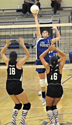 Erica Smith (1) sends a hit over the net. (Photo by Kevin Nagle)