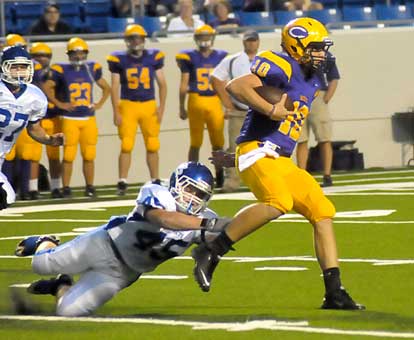 Collin Chapdelaine dives for the ankles of Catholic quarterback Zach Conque. (Photo by Kevin Nagle)