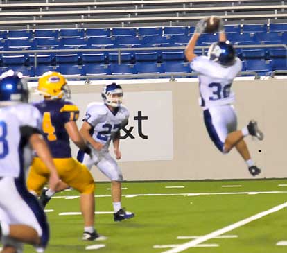 Holden Chavis (30) leaps to make an interception in front of teammate Jacob Brady and Little Rock Catholic receiver Scott Scruggs (14). (Photo by Kevin Nagle)