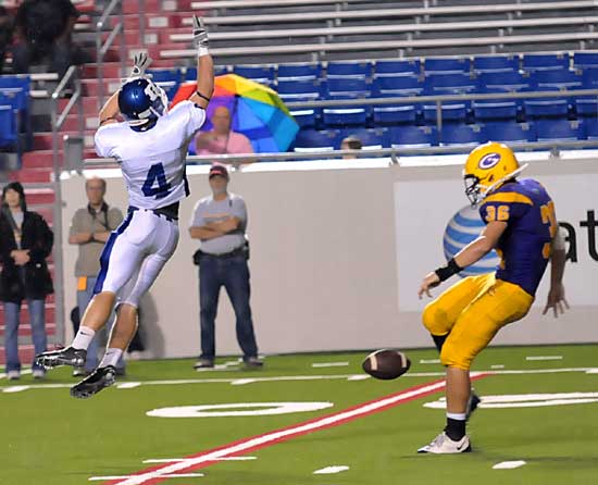 Tyler Freshour (4) stretches out to block Jordan Hartnedy's punt. (Photo by Kevin Nagle)