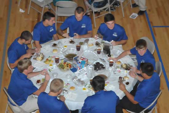 A table of Hornets players enjoy the evening's fare. (Photo by Kevin Nagle)