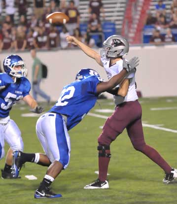 Bryant's James Kidd gets to Benton quarterback Grant Jones just after he releases his pass. (Photo by Kevin Nagle)