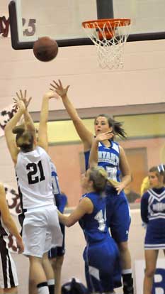 Bryant's Aubrey Allen (23) and Caylin Choate (14) defend against Benton's Carmen King. (Photo by Kevin Nagle)