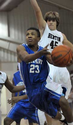 C.J. Rainey (23) drives past Benton's Nic Sanchez. (Photo by Kevin Nagle)