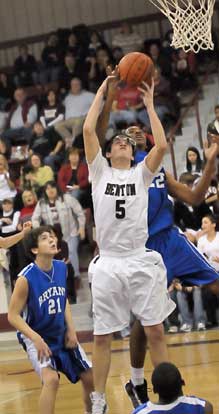 Bryant's Brian Reed and Benton's Garrett King (5) fight for a rebound as Caleb Strain (21) looks on. (Photo by Kevin Nagle)