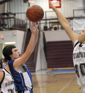 Connor Tatum, left, tries to get a show away over a Benton defender. (Photo by Kevin Nagle)