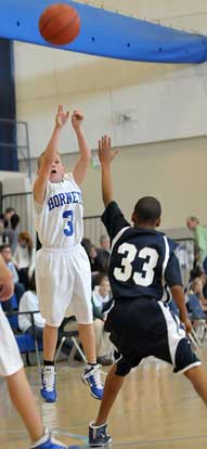 Logan Allen takes a shot over a Little Rock Christian defender. (Photo by Kevin Nagle)