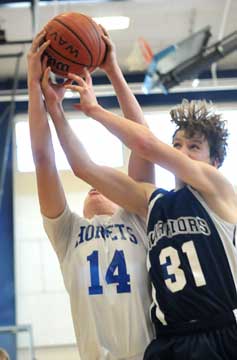 Devin Howard, left, fights for a rebound. (Photo by Kevin Nagle)