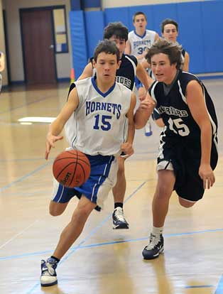 Bryant Blue's Brandon Warner (15) leads the pack up the floor on the way to 2 of his team-high 16 points Saturday. (photo by Kevin Nagle)