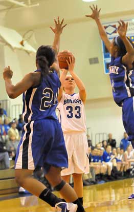 Abbi Stearns launches a shot over Bre Hobbs (24) and Taylor Gault. (Photo by Kevin Nagle)