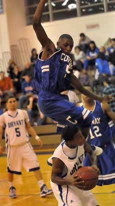 Marcus Wilson gets Conway's Tim Boyd in the air with a pump fake and draws a foul as teammate Jordan Griffin and Conway's T-Shawn Sims (12) look on. (Photo by Kevin Nagle)