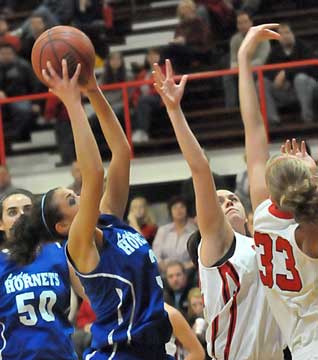 McKenzie Adams pulls down a rebound. (Photo by Kevin Nagle)