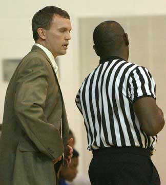 Bryant coach Mike Abrahamson discusses a call with one of Tuesday night's officials. (Photo by Rick Nation)