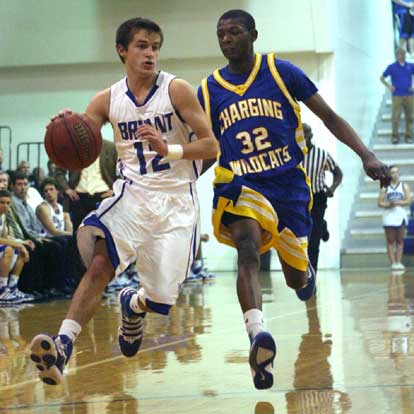 Brantley Cozart (12) drives around North Little Rock's Reggie Bryles (32). (Photo by Rick Nation)