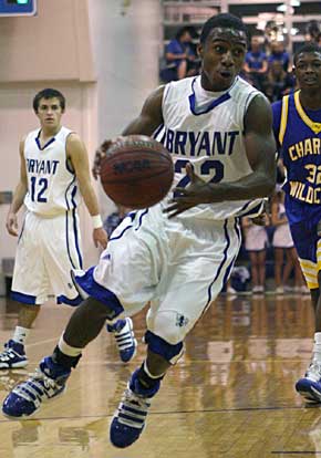 Marcus Wilson (22) drives to the hoop. (Photo by Rick Nation)