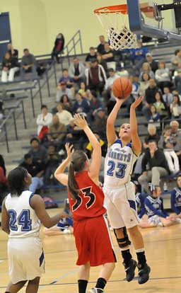 Aubree Allen puts up a shot in front of Cabot's Amanda Brucks (33) and teammate Dezerea Duckworth (24). (Photo by Kevin Nagle)