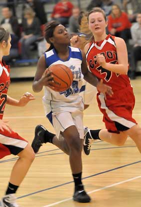 Bryant's Kaitlyn Greer splits a pair of Cabot South defenders on the way to the basket. (Photo by Kevin Nagle)