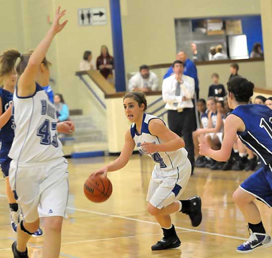 Caylin Choate works the ball up the floor as teammate Amber Newman (43) breaks open ahead of her defender. (Photo by Kevin Nagle)