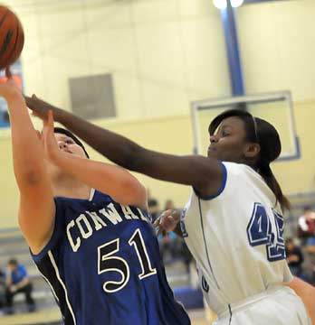 Bryant's Kaitlyn Greer, right, gets her money's worth as she fouls Conway's Fallen Middleton (51). (Photo by Keven Nagle)