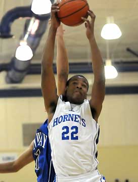 Brian Reed (22) collects a rebound for the Hornets. (Photo by Kevin Nagle)