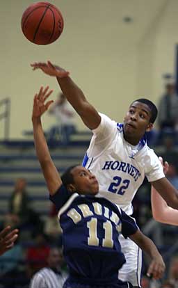 Bryant's Brian Reed tries to block a shot by Pulaski Academy guard Marcus Wallace. (Photo by Rick Nation)