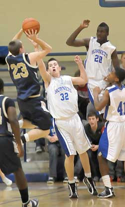 Pulaski Academy's Blake Wiggins (23) puts up a shot over Bryant's Mitch Scoggins (32) and Greyson Giles (20). (Photo by Kevin Nagle)