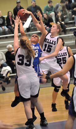 Abbi Stearns fights to get a shot away over Mallory Kleine (33) and Emily Sprick (15). (Photo by Kevin Nagle)