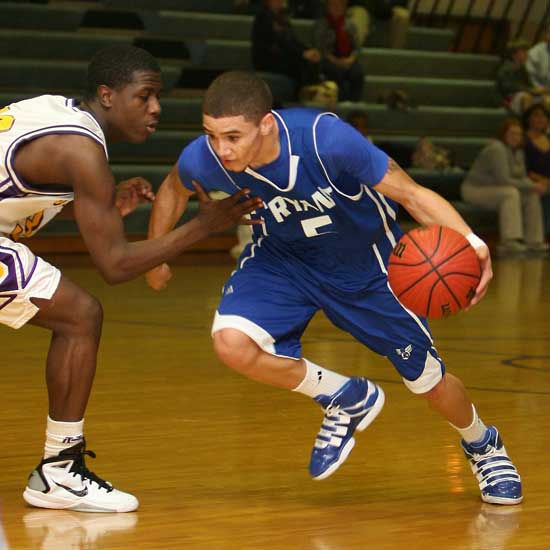 Bryant's Jordan Griffin (5) tries to fight through a hand check by Catholic's Evan James on a drive during Friday night's game. (Photo by Rick Nation)