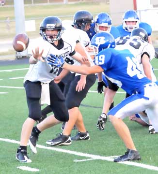 Johnny Austin (49) pressures Bauxite's quarterback. (Photo by Kevin Nagle)