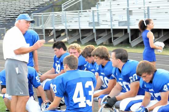 Bryant coach Brad Stroud meets with the defense during Monday night's game. (Photo by Kevin Nagle)