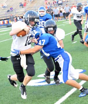 Noah Varner (47) makes a tackle as teammate Colton Burton (38) trails the play. (Photo by Kevin Nagle)